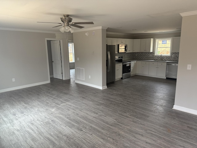 1800 Hardy Rd, Vinton, VA 24179 - kitchen featuring appliances with stainless steel finishes, open floor plan, crown molding, baseboards, and tasteful backsplash