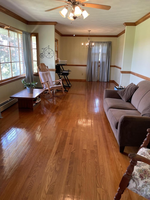 living area featuring ceiling fan, healthy amount of natural light, hardwood / wood-style floors, baseboards, and ornamental molding