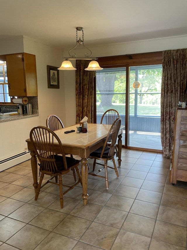 dining room featuring a baseboard heating unit and light tile patterned floors
