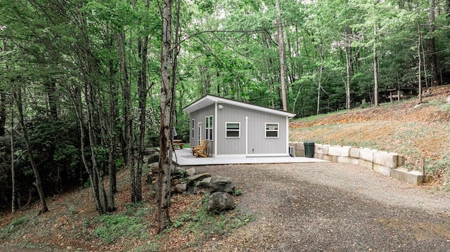3119 Buffalo Mountain Rd SW, Willis, VA 24380 - view of front of house featuring an outdoor structure, a wooded view, and gravel driveway