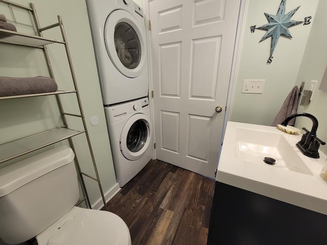3119 Buffalo Mountain Rd SW, Willis, VA 24380 - bathroom with estacked washer and dryer, toilet, wood finished floors, and vanity
