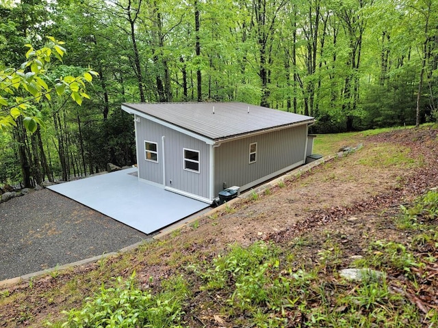 3119 Buffalo Mountain Rd SW, Willis, VA 24380 - rear view of house featuring a patio area, metal roof, and a wooded view