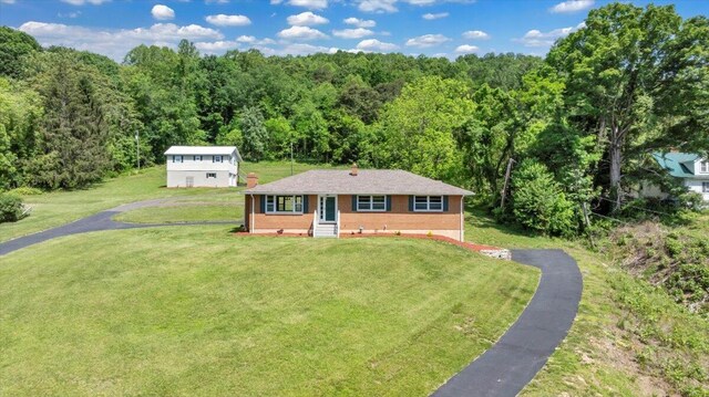 1104 Dolly Ann Dr, Covington, VA 24426 - view of front facade with a wooded view, asphalt driveway, and a front lawn