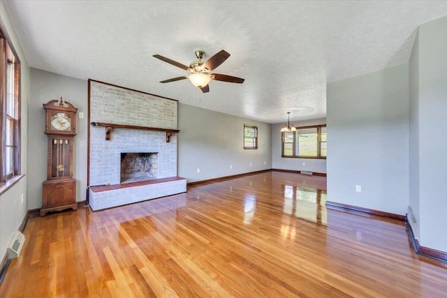 1104 Dolly Ann Dr, Covington, VA 24426 - unfurnished living room featuring ceiling fan, light wood-type flooring, a fireplace, and baseboards