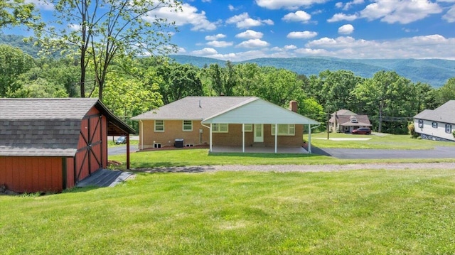 1104 Dolly Ann Dr, Covington, VA 24426 - rear view of house featuring a lawn, a view of trees, and a chimney