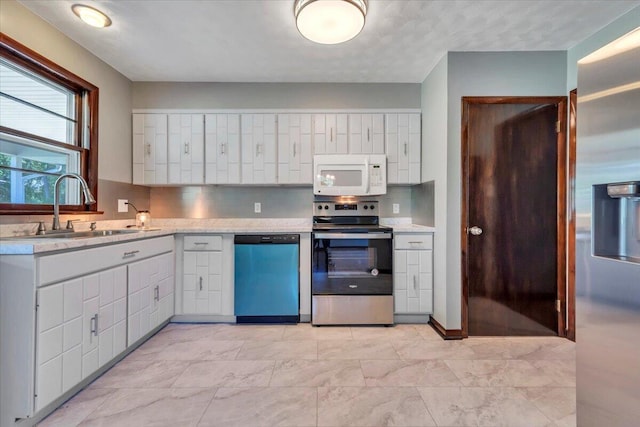 1104 Dolly Ann Dr, Covington, VA 24426 - kitchen featuring white microwave, electric range, dishwasher, a sink, and white cabinets