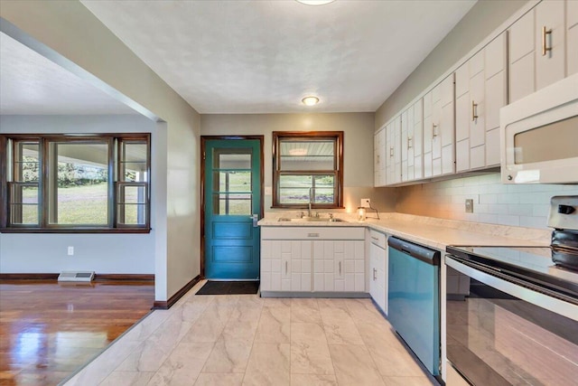 1104 Dolly Ann Dr, Covington, VA 24426 - kitchen with electric range oven, dishwashing machine, white microwave, and light countertops