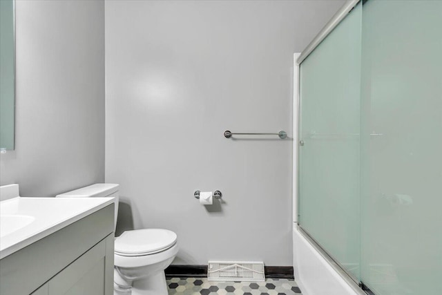 1104 Dolly Ann Dr, Covington, VA 24426 - bathroom with vanity, toilet, baseboards, and combined bath / shower with glass door