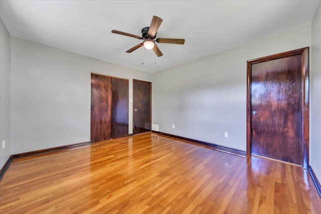 1104 Dolly Ann Dr, Covington, VA 24426 - unfurnished bedroom featuring multiple closets, light wood-style flooring, baseboards, and ceiling fan