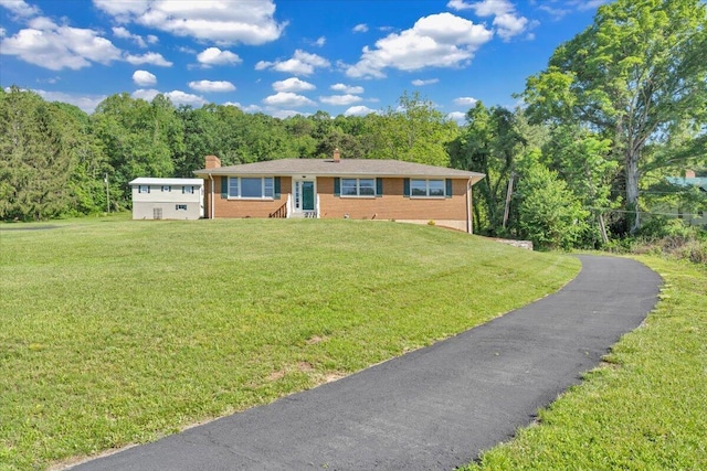 1104 Dolly Ann Dr, Covington, VA 24426 - ranch-style home with a chimney, brick siding, a front yard, and a view of trees