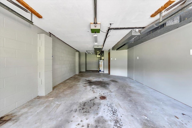 1104 Dolly Ann Dr, Covington, VA 24426 - garage with gas water heater, concrete block wall, and a garage door opener