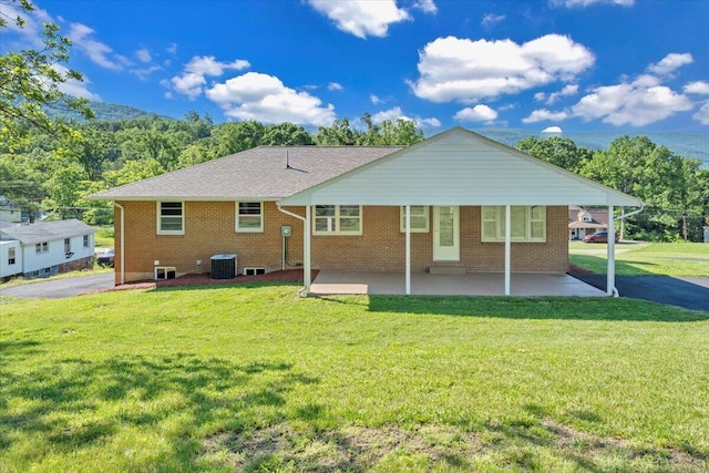 1104 Dolly Ann Dr, Covington, VA 24426 - rear view of house with a patio area, a yard, central AC, and brick siding