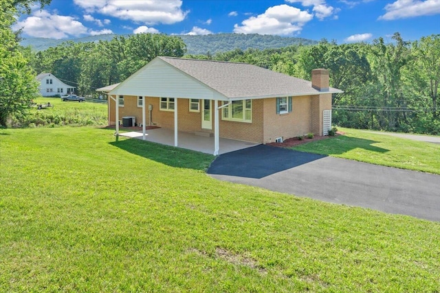 1104 Dolly Ann Dr, Covington, VA 24426 - ranch-style house with central AC, driveway, a chimney, a front yard, and brick siding