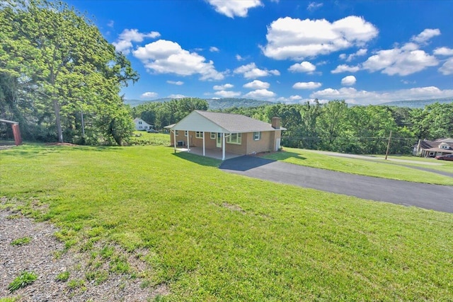 1104 Dolly Ann Dr, Covington, VA 24426 - view of front of house featuring a chimney and a front lawn