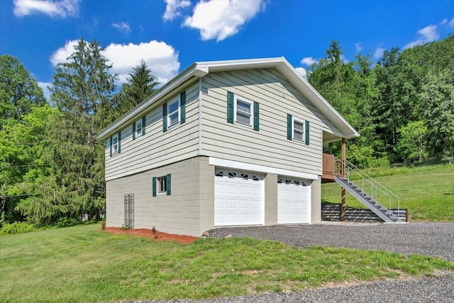 1104 Dolly Ann Dr, Covington, VA 24426 - view of home's exterior featuring stairway, an attached garage, a yard, and driveway