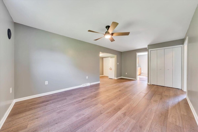 1104 Dolly Ann Dr, Covington, VA 24426 - unfurnished bedroom with light wood-style flooring, baseboards, a closet, ensuite bath, and ceiling fan