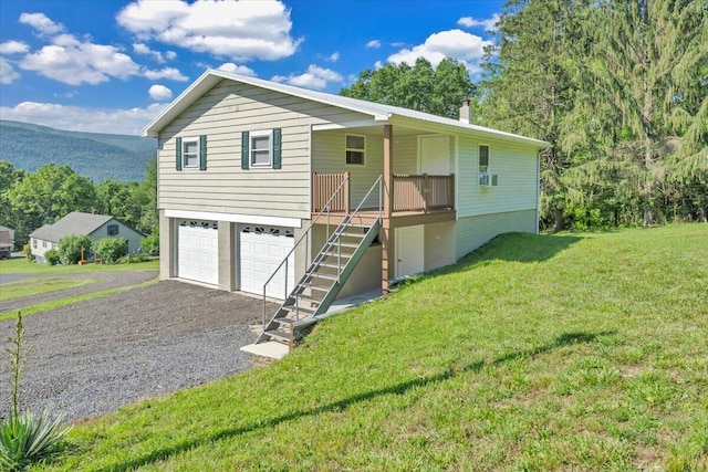 1104 Dolly Ann Dr, Covington, VA 24426 - view of front of property featuring stairway, a front lawn, an attached garage, asphalt driveway, and a porch