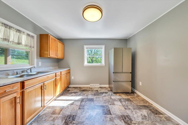 1104 Dolly Ann Dr, Covington, VA 24426 - kitchen featuring freestanding refrigerator, stone finish flooring, a sink, baseboards, and ornamental molding