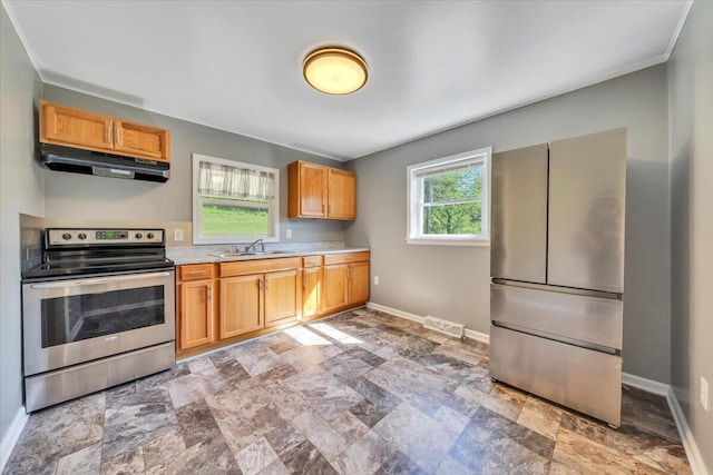 1104 Dolly Ann Dr, Covington, VA 24426 - kitchen with stainless steel range with electric cooktop, under cabinet range hood, a sink, light countertops, and stone finish floors