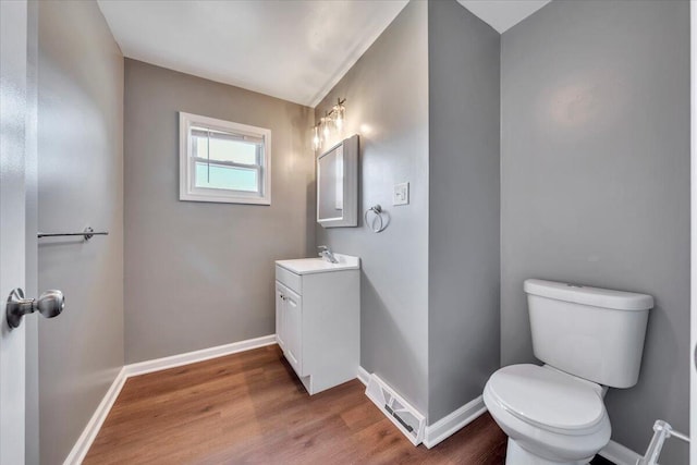 1104 Dolly Ann Dr, Covington, VA 24426 - half bath with wood finished floors, toilet, baseboards, and vanity
