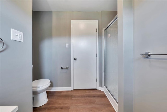 1104 Dolly Ann Dr, Covington, VA 24426 - full bath with a stall shower, wood finished floors, toilet, and baseboards