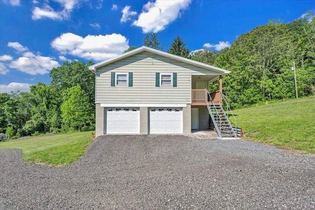 1104 Dolly Ann Dr, Covington, VA 24426 - view of front of property with stairway, a front yard, gravel driveway, and an attached garage