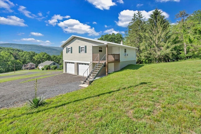 1104 Dolly Ann Dr, Covington, VA 24426 - view of front facade with stairway, driveway, a garage, and a front yard