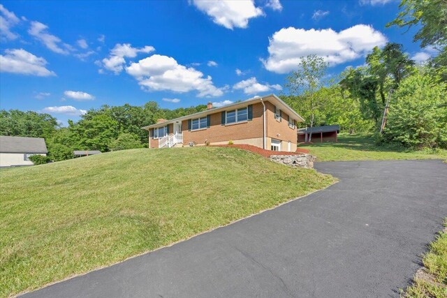 1104 Dolly Ann Dr, Covington, VA 24426 - ranch-style house with a chimney, brick siding, a front lawn, and asphalt driveway