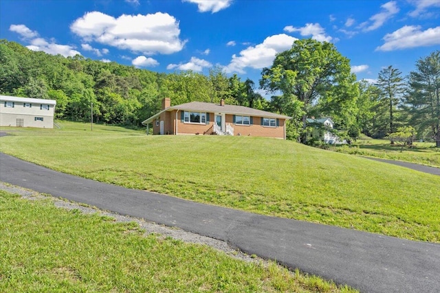 1104 Dolly Ann Dr, Covington, VA 24426 - view of front of property with a chimney, a front yard, and a view of trees