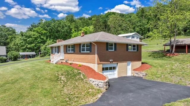 1104 Dolly Ann Dr, Covington, VA 24426 - view of front of home with an attached garage, asphalt driveway, a chimney, brick siding, and a front lawn