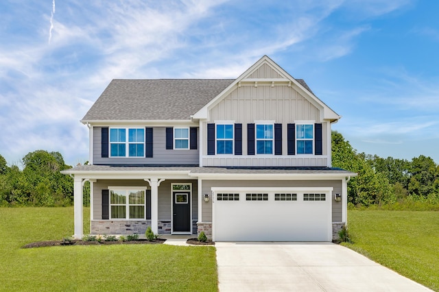 craftsman house featuring board and batten siding, driveway, an attached garage, and a front lawn