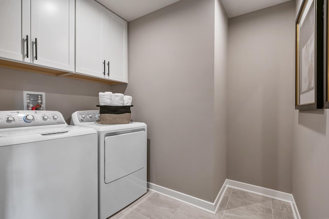 laundry room with cabinet space, washing machine and dryer, and baseboards