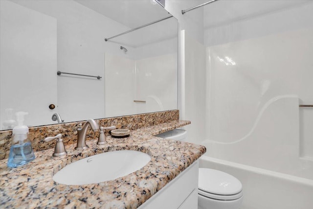 full bathroom with toilet, vanity, and shower / bathtub combination