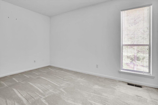 spare room with carpet and baseboards