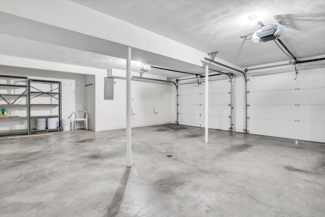 garage featuring a garage door opener and electric panel