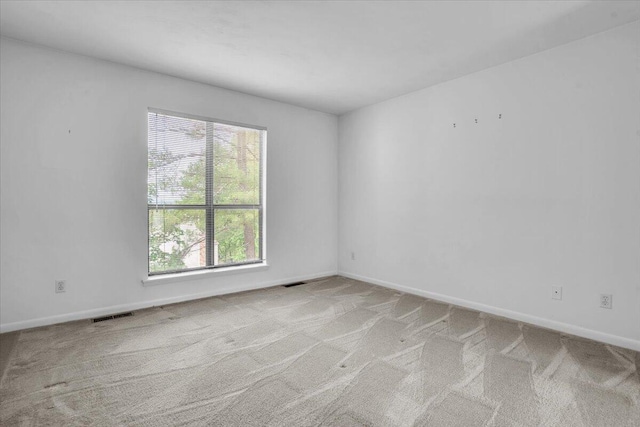 spare room with carpet and baseboards