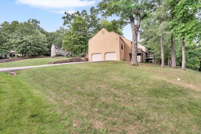 view of green lawn with a garage
