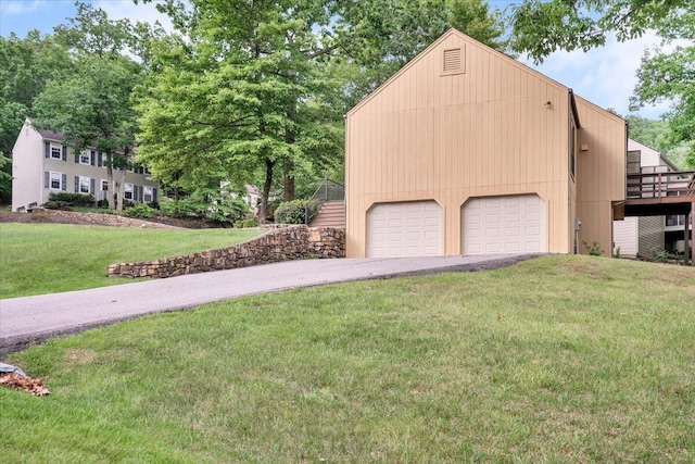 view of property exterior featuring a lawn and driveway