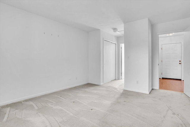 carpeted spare room with baseboards