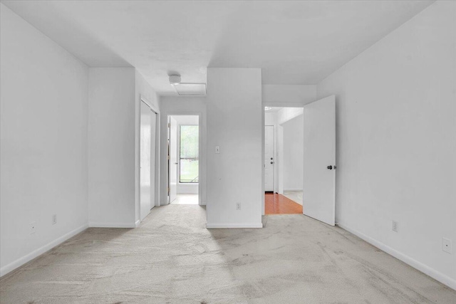 carpeted empty room with baseboards
