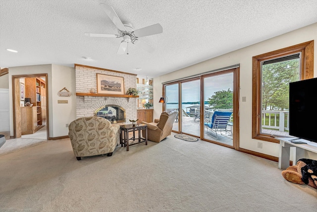 217 Anthony Home Rd, Huddleston, VA 24104 - living area with carpet floors, a textured ceiling, a brick fireplace, ceiling fan, and baseboards