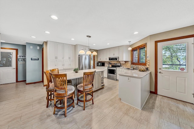 217 Anthony Home Rd, Huddleston, VA 24104 - kitchen featuring appliances with stainless steel finishes, a sink, light countertops, tasteful backsplash, and baseboards