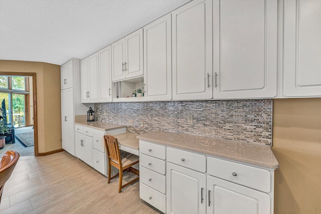 217 Anthony Home Rd, Huddleston, VA 24104 - kitchen featuring tasteful backsplash, open shelves, white cabinetry, light wood-style flooring, and light countertops