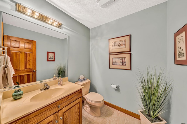 217 Anthony Home Rd, Huddleston, VA 24104 - half bathroom with toilet, a textured ceiling, vanity, wood finished floors, and baseboards