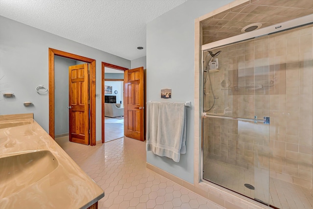 217 Anthony Home Rd, Huddleston, VA 24104 - bathroom with a shower stall, tile patterned flooring, baseboards, double vanity, and a textured ceiling