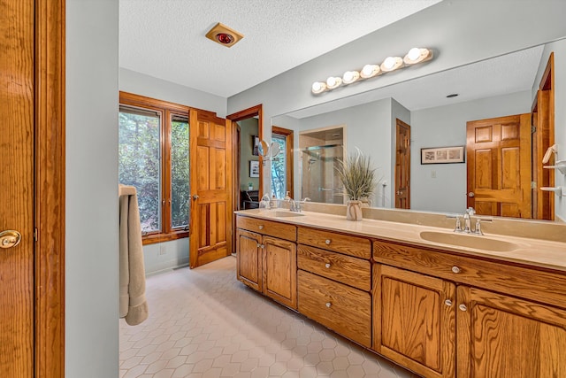 217 Anthony Home Rd, Huddleston, VA 24104 - bathroom featuring a stall shower, double vanity, a textured ceiling, and tile patterned floors