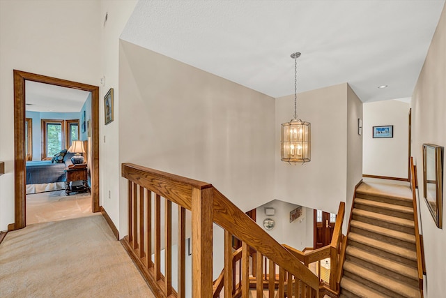 217 Anthony Home Rd, Huddleston, VA 24104 - corridor featuring light carpet, a chandelier, stairway, and baseboards