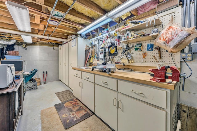 217 Anthony Home Rd, Huddleston, VA 24104 - unfinished below grade area with a workshop area and concrete block wall