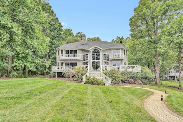 217 Anthony Home Rd, Huddleston, VA 24104 - back of property with a chimney, a balcony, a yard, stairs, and a wooden deck