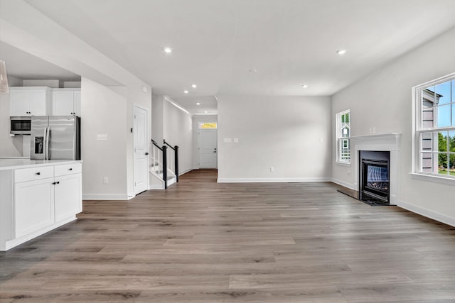 7036 Fairway Ridge Rd, Salem, VA 24153 - unfurnished living room with stairway, recessed lighting, light wood-style floors, baseboards, and a fireplace